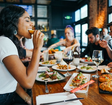 woman in white shirt eating