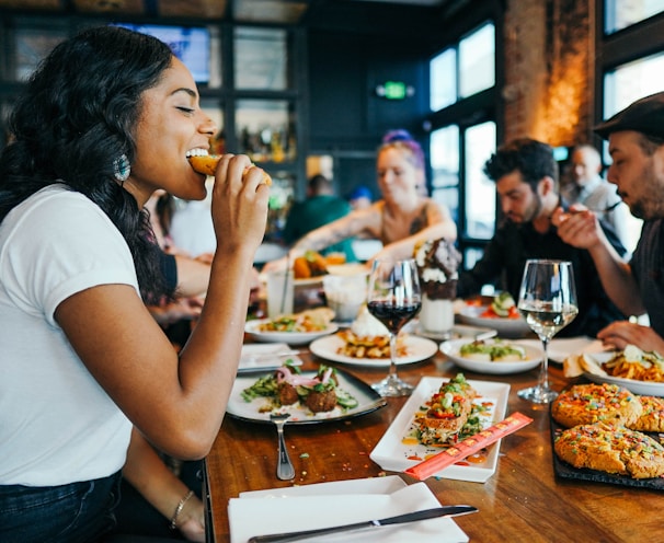 woman in white shirt eating