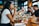 A diverse group of people enjoying a meal together at a restaurant.