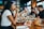 A diverse group of people enjoying a meal together at a restaurant.
