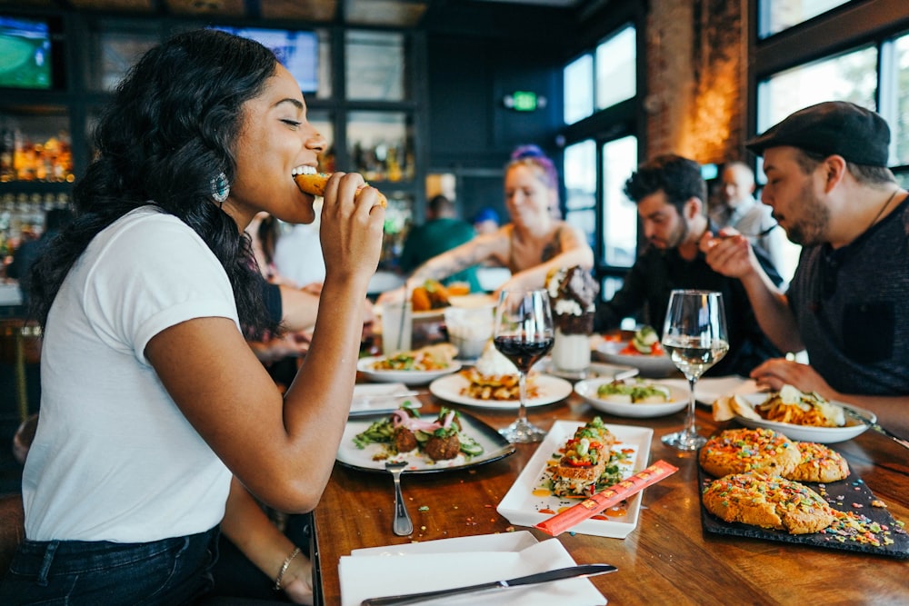 woman in white shirt eating