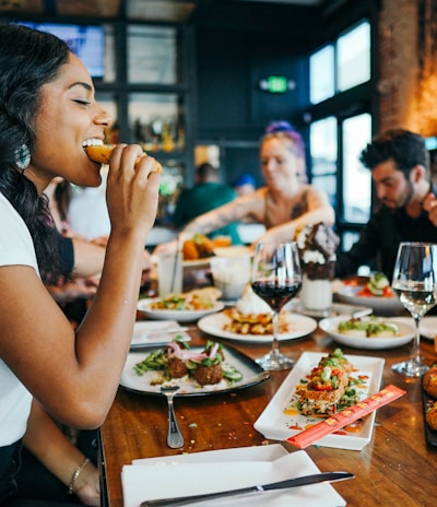 woman in white shirt eating