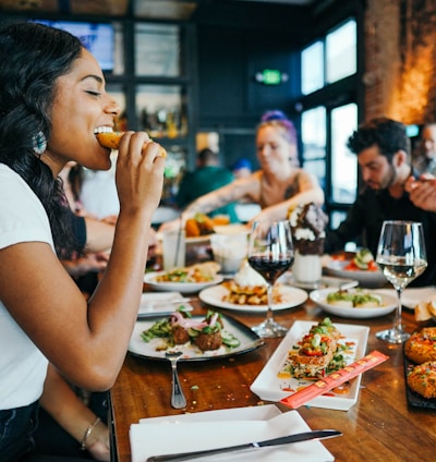 woman in white shirt eating