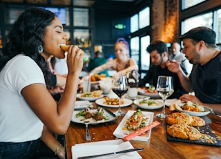 woman in white shirt eating