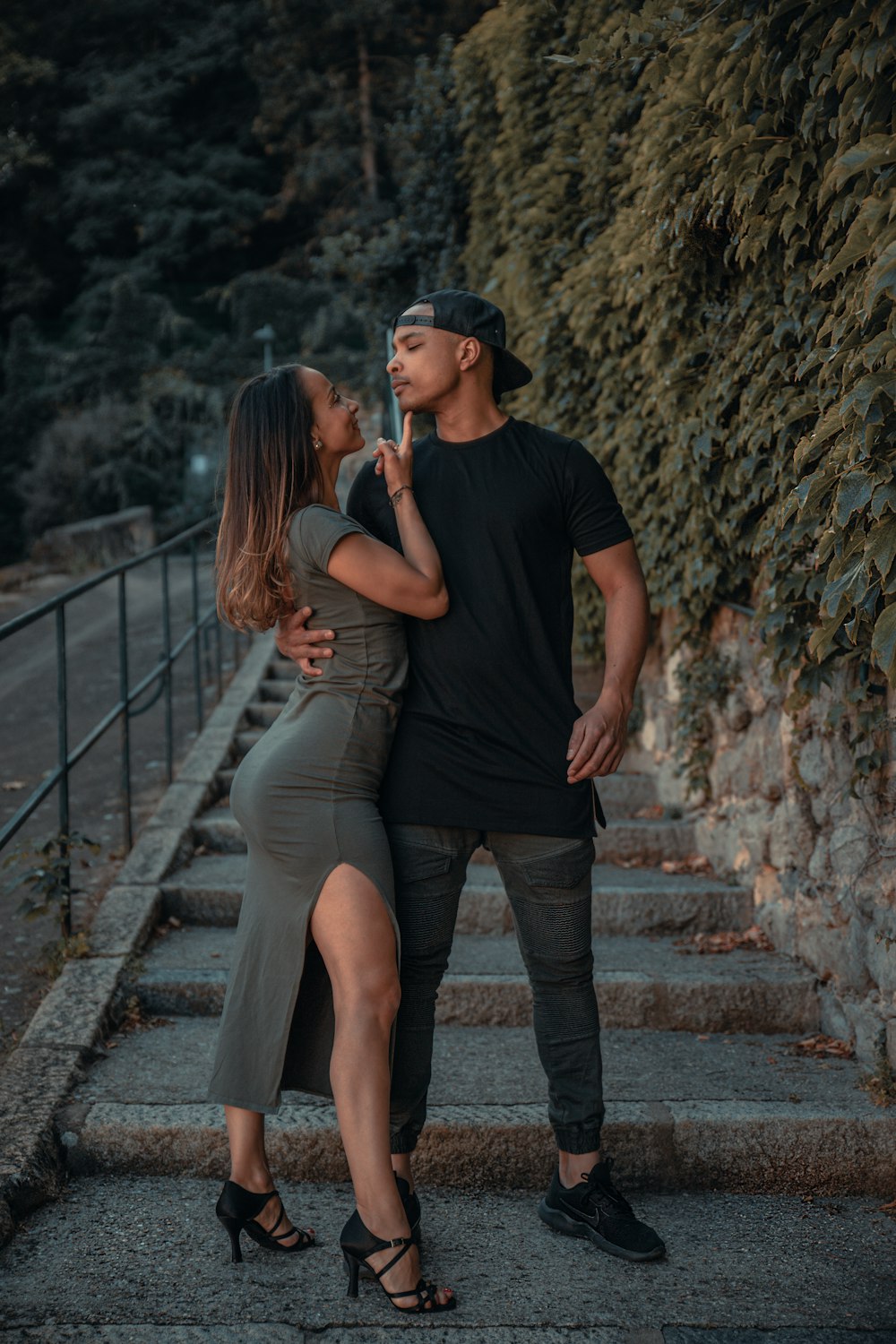 man in black crew neck t-shirt and woman in gray tank top standing on brown