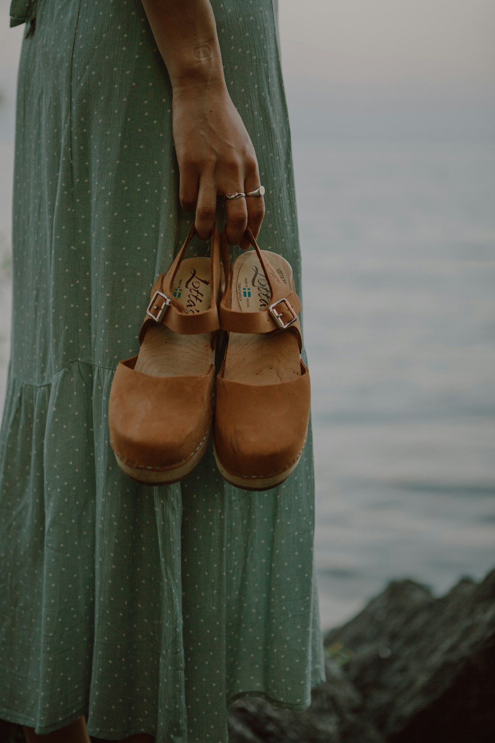 brown leather shoes on green textile