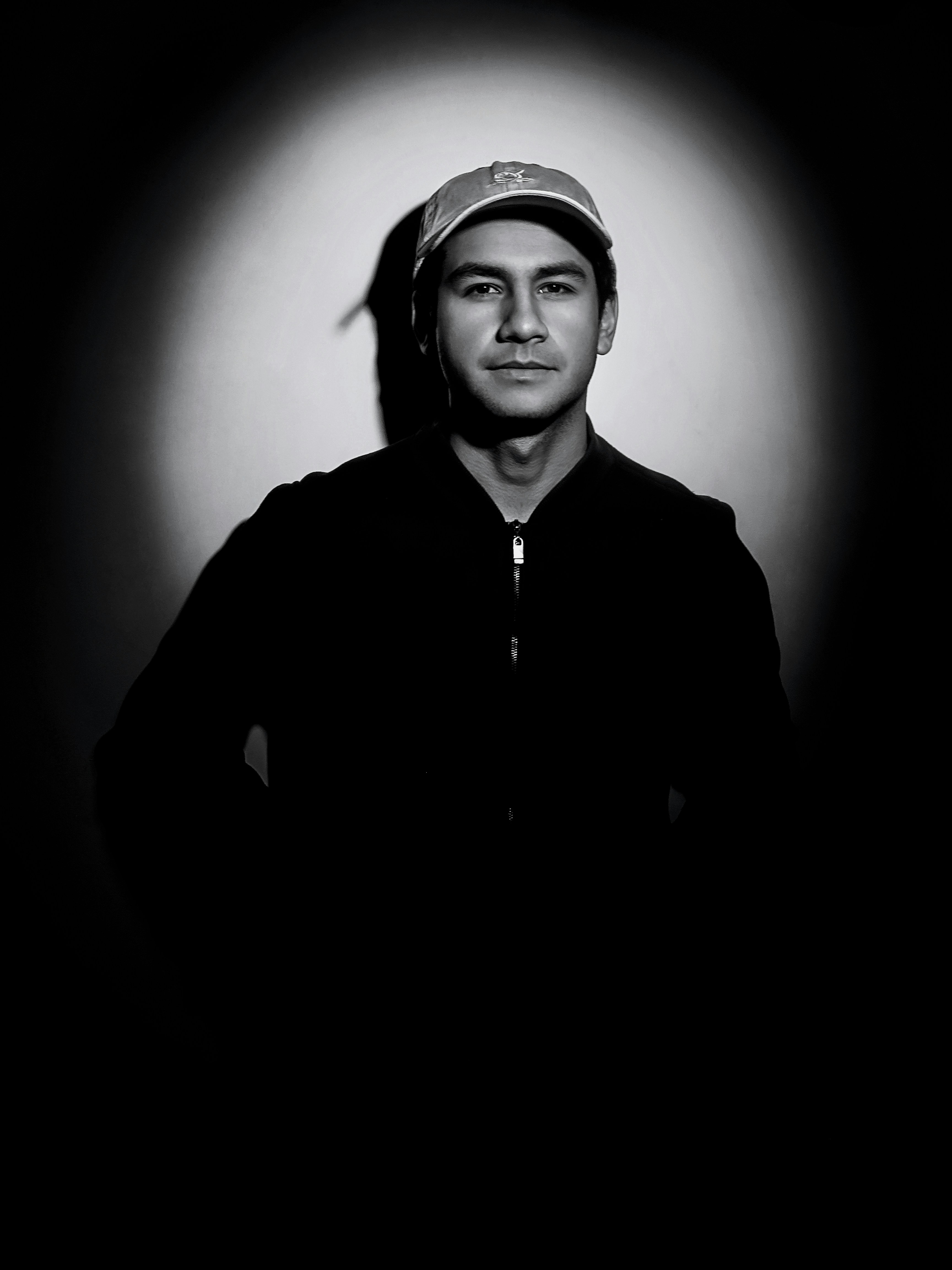 grayscale photo of woman in black jacket and white cap
