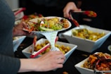 person holding white ceramic bowl with food