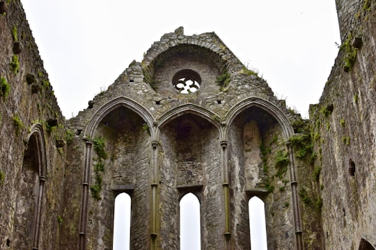 gray concrete building under white sky during daytime in Rock of Cashel Ireland