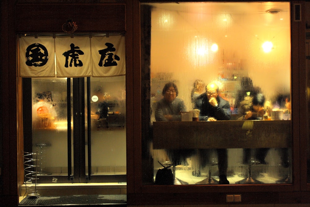 people sitting on chair in front of table