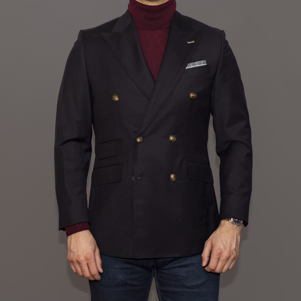 Tailor adjusting a black suit jacket for a perfect fit