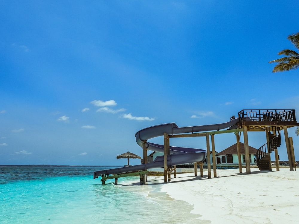 brown wooden beach lounge chairs on beach during daytime