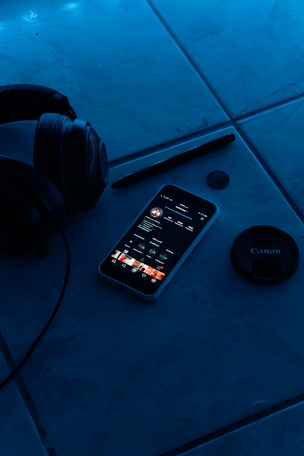 black samsung android smartphone beside black headphones
