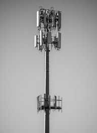 grayscale photo of black and white electric tower