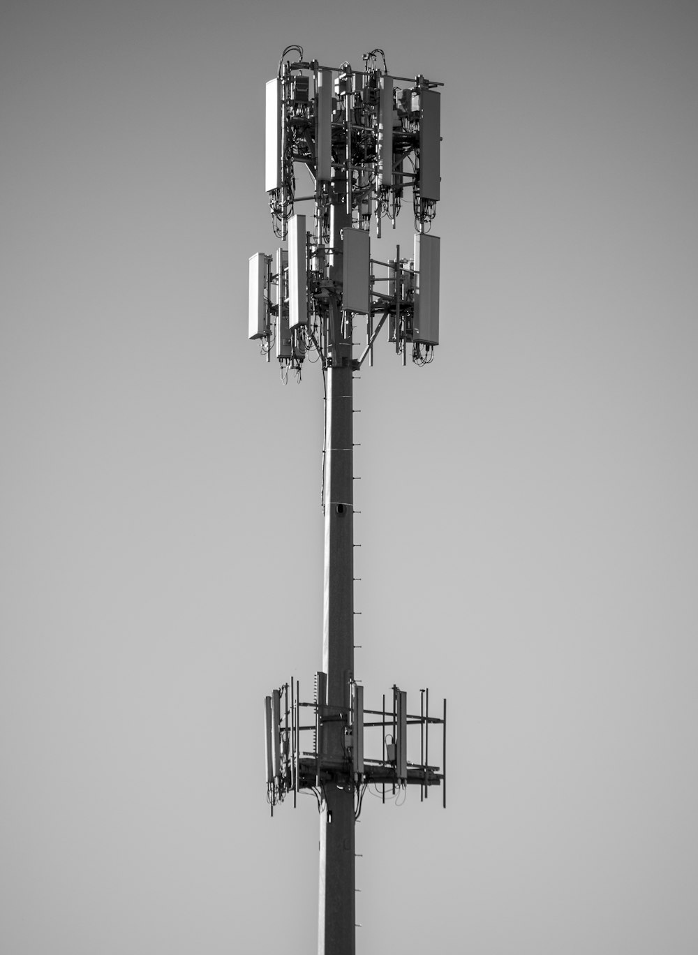 grayscale photo of black and white electric tower