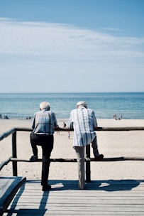 man and woman standing on beach during daytime