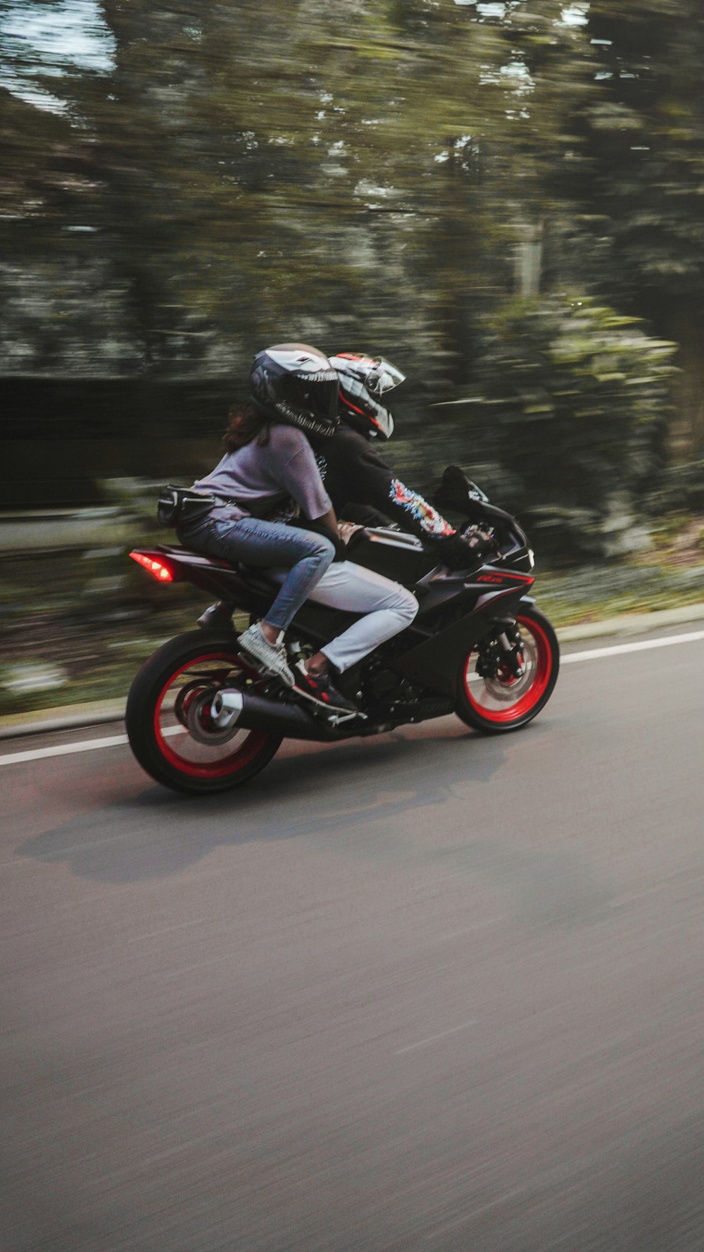 man riding on black sports bike on road during daytime