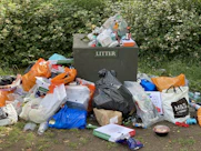 garbage bags on green grass field