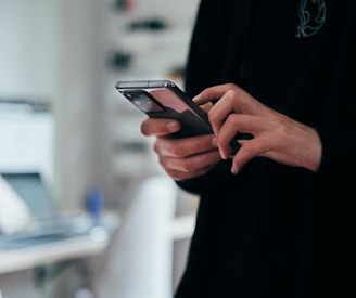 person holding black android smartphone