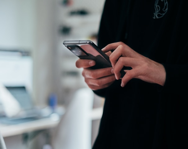 person holding black android smartphone