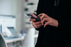 person holding black android smartphone