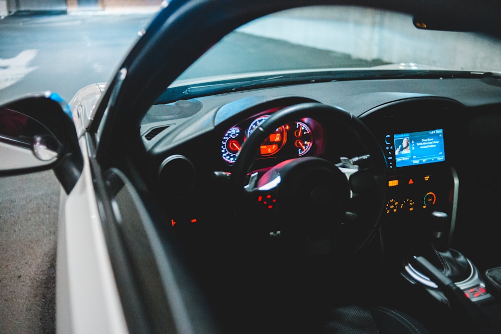 black car steering wheel during daytime