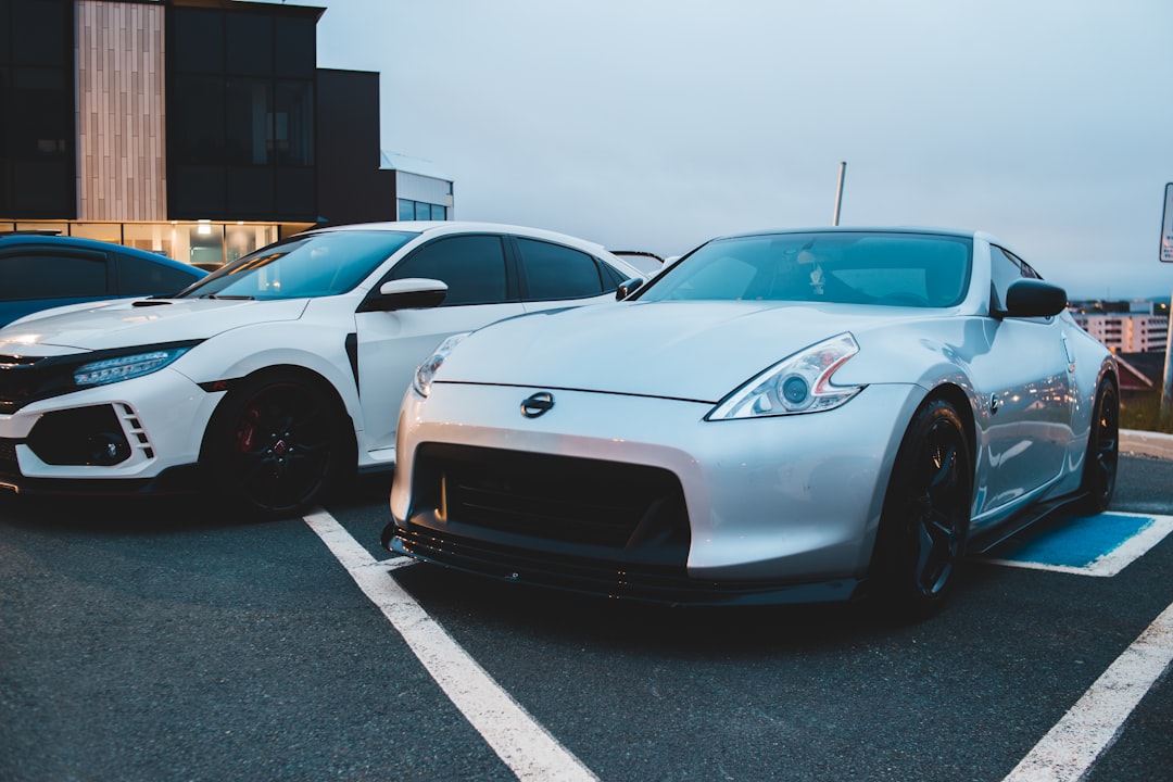 white porsche 911 parked on parking lot during daytime