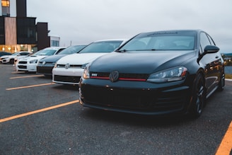 black bmw car on parking lot during daytime