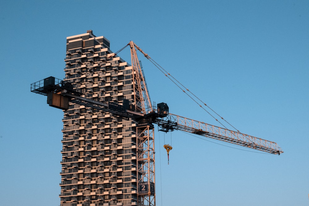 black crane near brown building during daytime