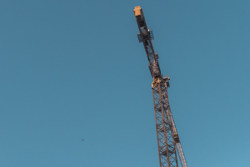 brown metal crane under blue sky during daytime