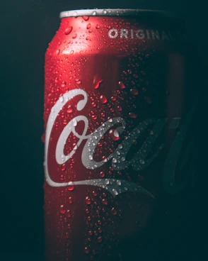 coca cola can on black surface