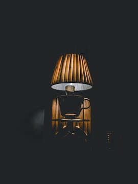 Dimly lit room featuring a vintage lamp casting warm light.