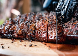 grilled meat on brown wooden chopping board