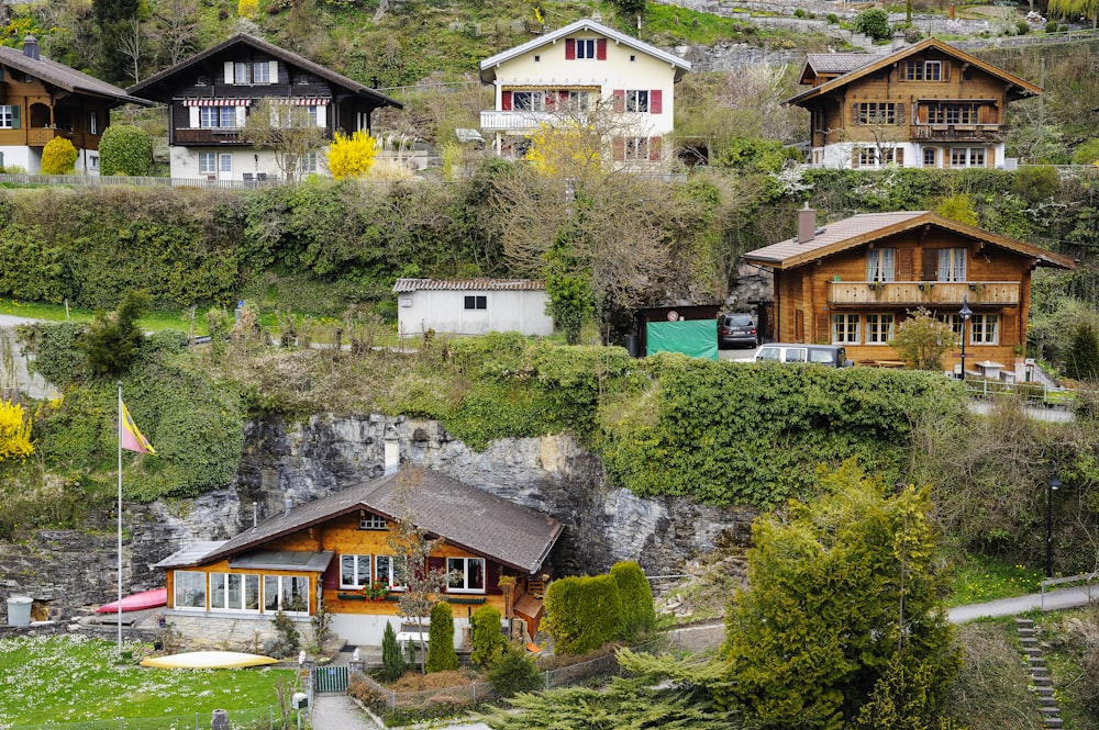 white and brown concrete houses near green trees during daytime