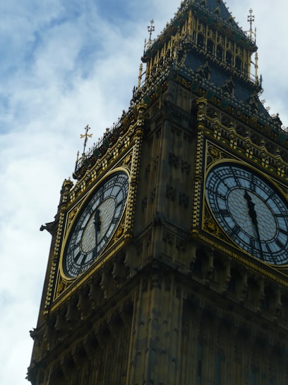 A close-up shot of the colorful clock face of Pachuca's monumental clock under a bright blue sky.