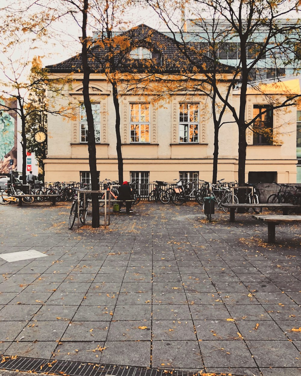 people sitting on bench near brown concrete building during daytime