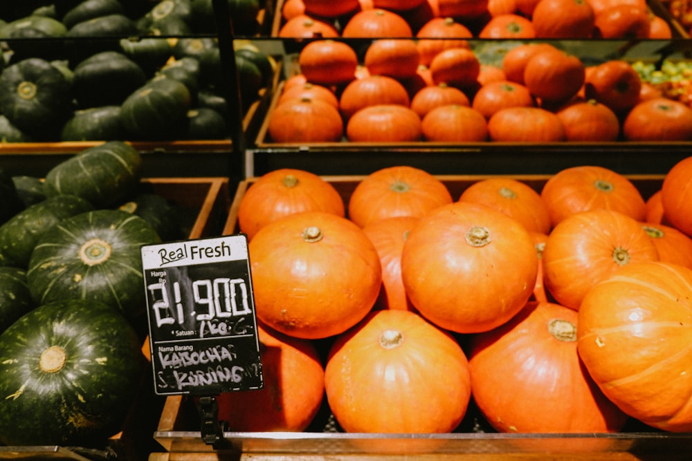 orange pumpkins on brown wooden crate