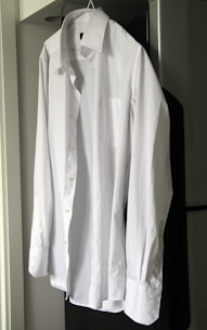 A close-up of a crisp white shirt with a tailored collar.