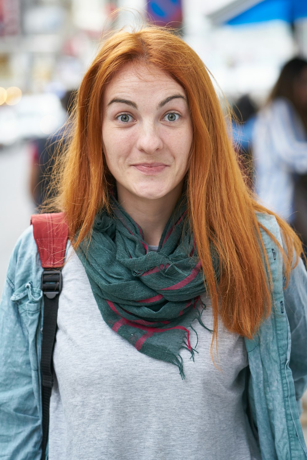 woman in gray shirt and gray scarf