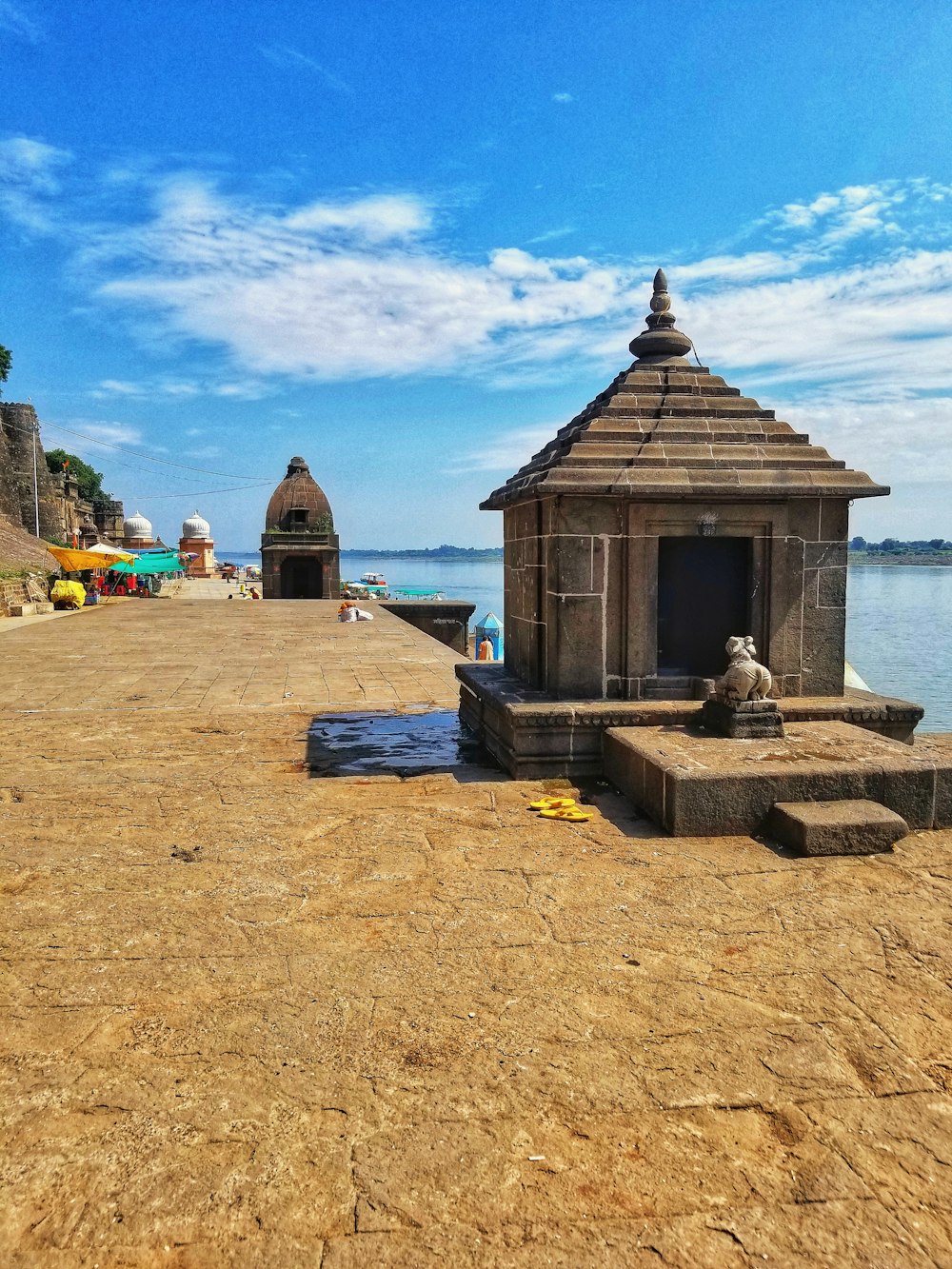 brown wooden house near body of water during daytime