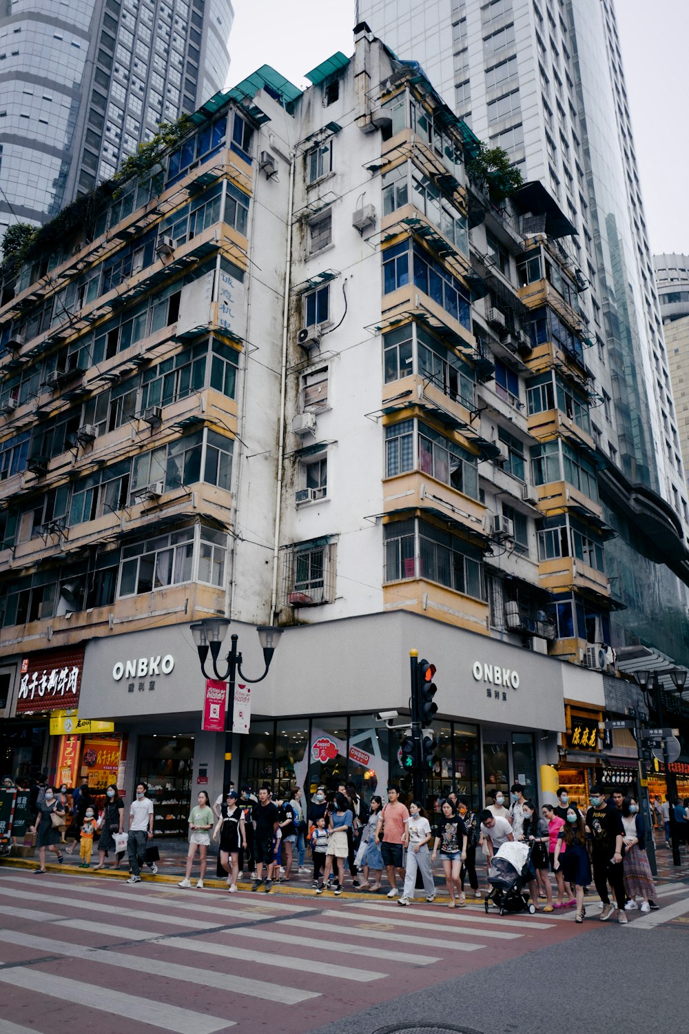 people walking on street near white concrete building during daytime