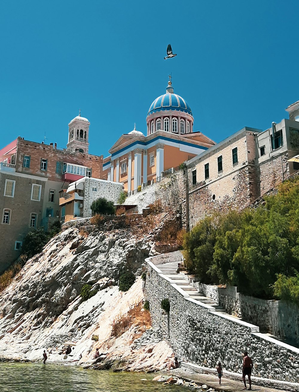 brown and white concrete building on top of mountain during daytime