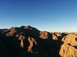 A sturdy mountain range under a clear sky symbolizing strength and stability.