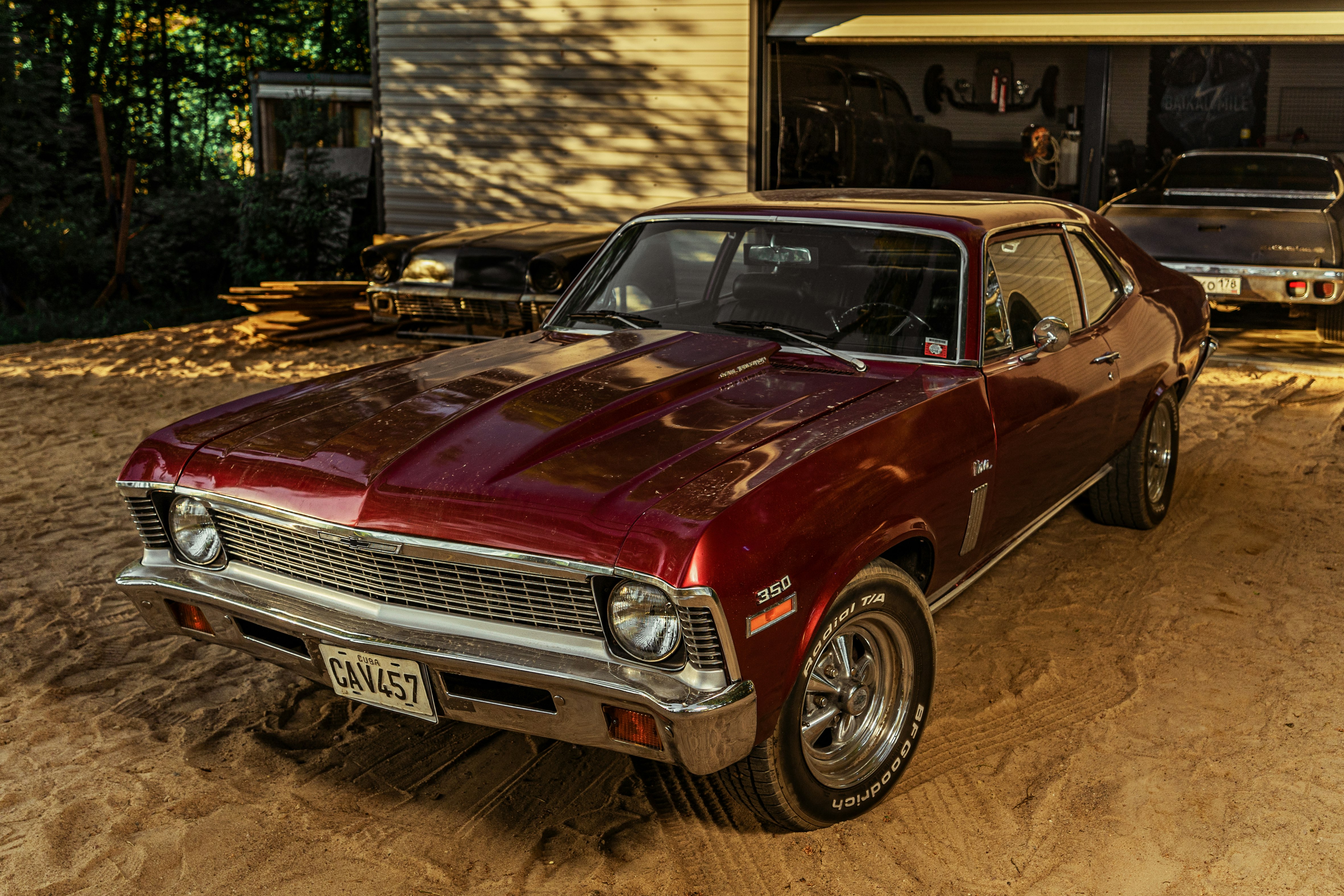 red chevrolet camaro parked in garage