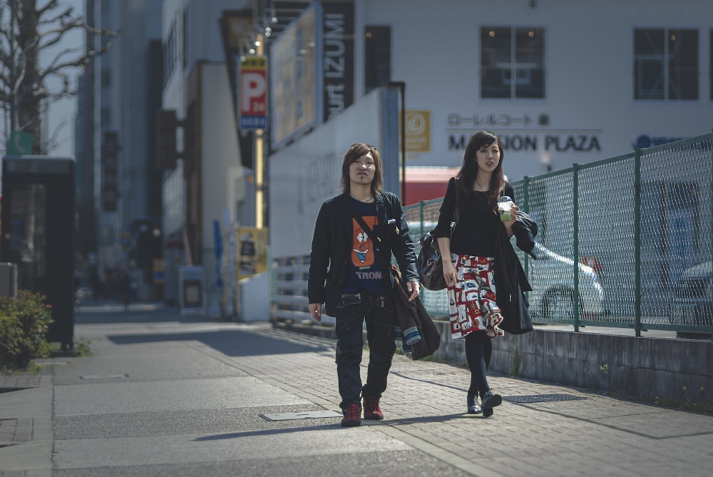 2 women standing on gray concrete floor during daytime