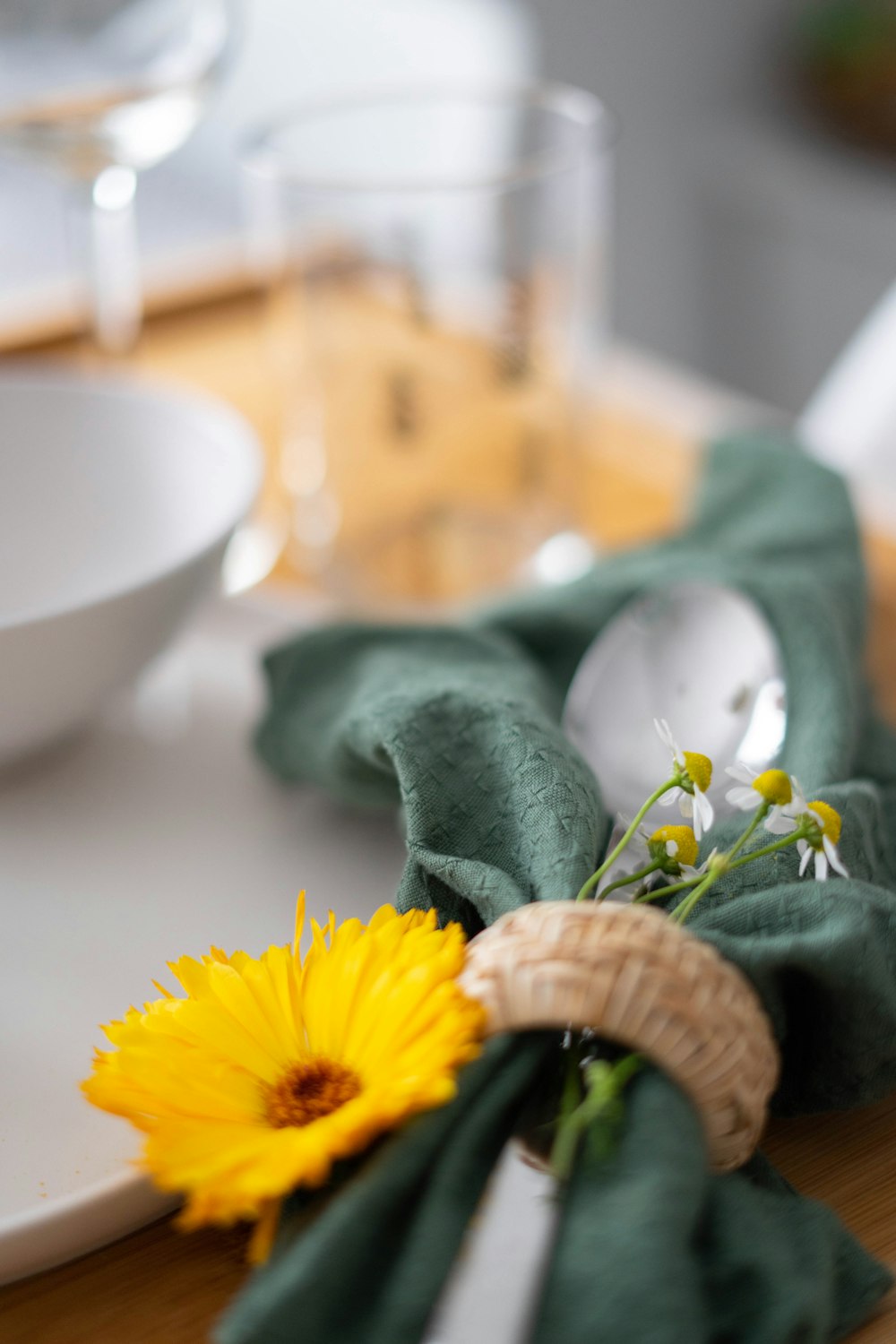 yellow sunflower beside white ceramic bowl