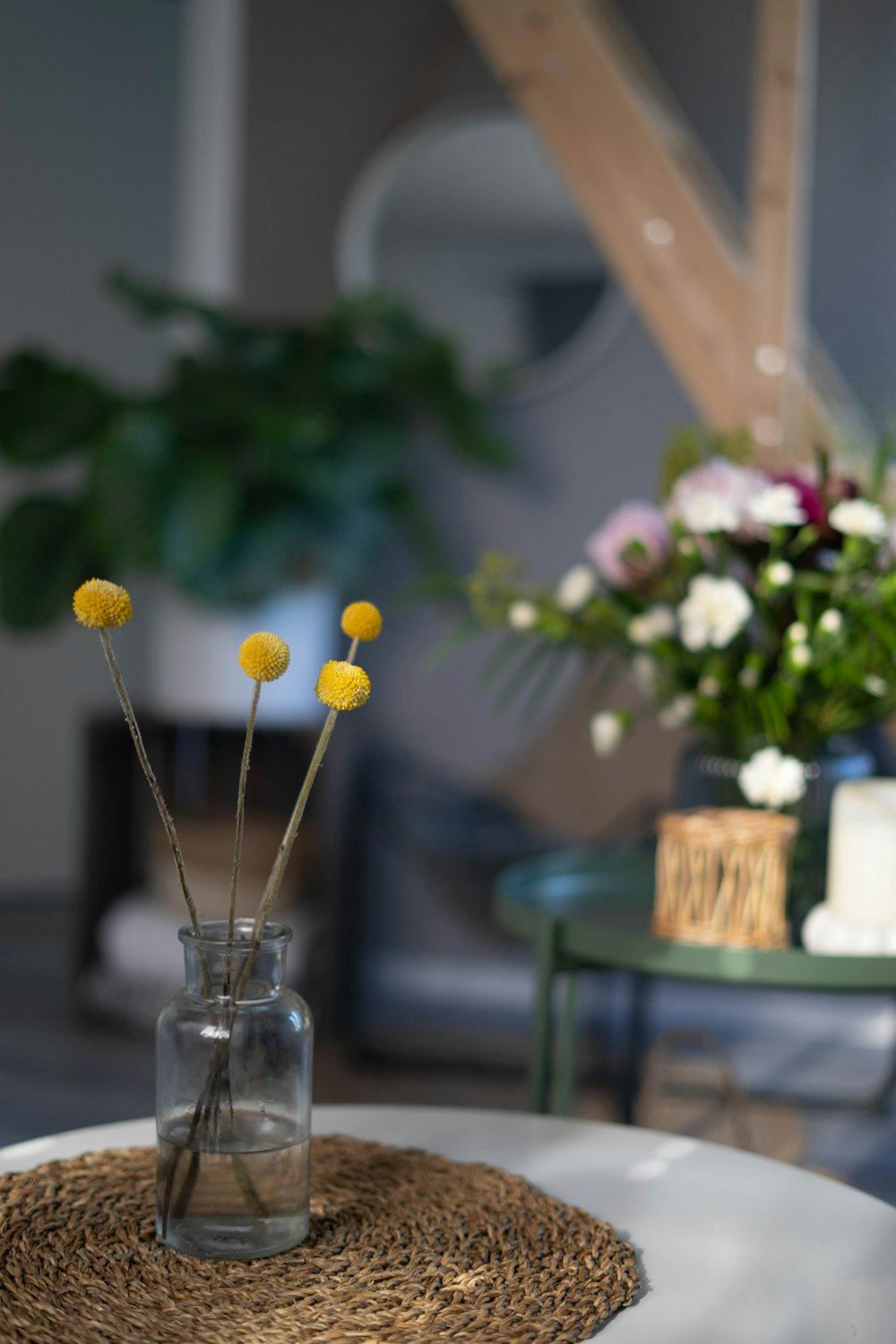 yellow and white flowers in clear glass vase