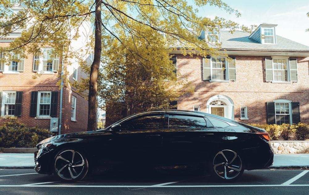 black bmw m 3 parked near brown tree during daytime