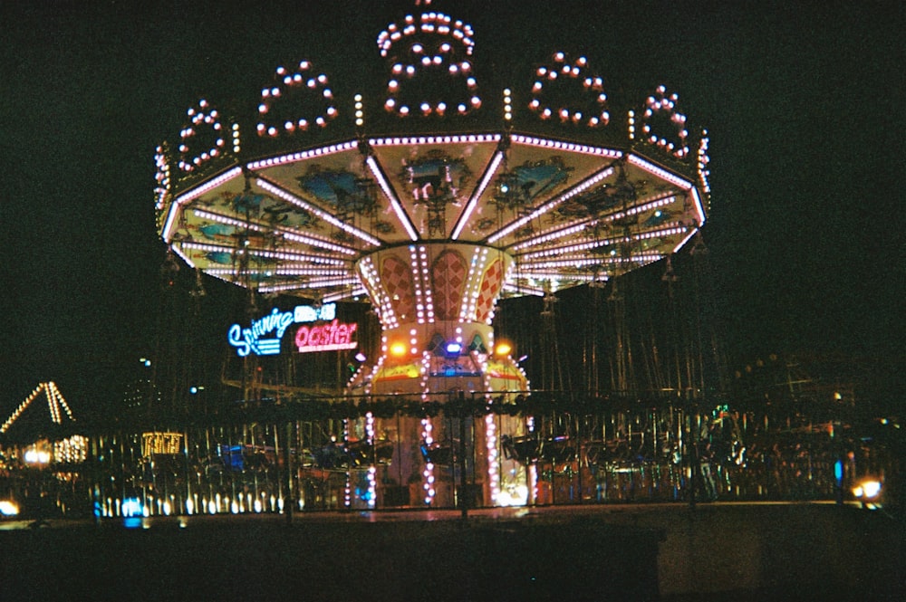 lighted carousel with lights turned on during night time