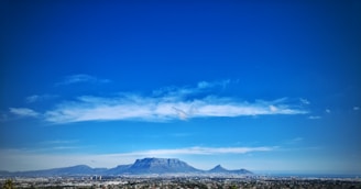 Table Mountain towering above Cape Town with a clear blue sky backdrop.